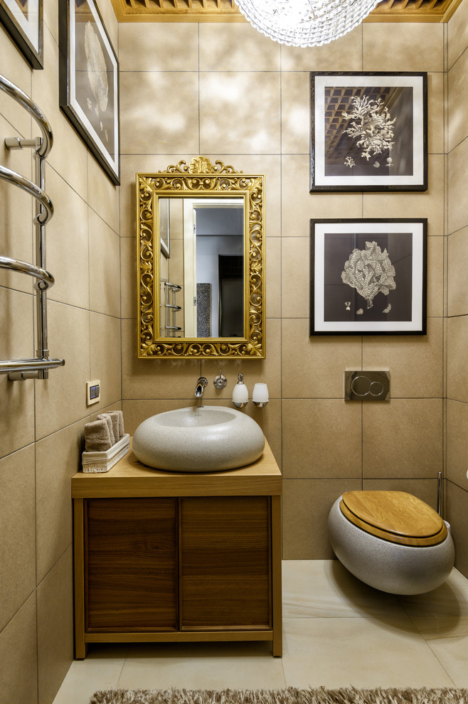 Contemporary powder room in Moscow with flat-panel cabinets, a wall-mount toilet, beige tile, a vessel sink, wood benchtops, beige floor, dark wood cabinets and brown benchtops.