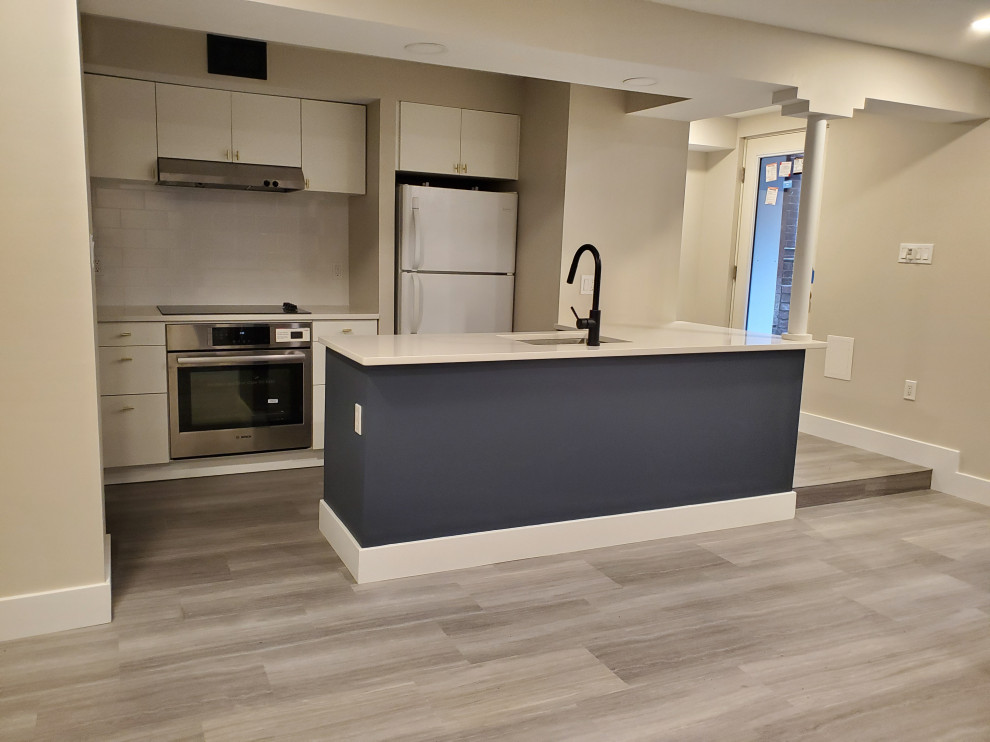 This is an example of a contemporary kitchen in DC Metro with vinyl floors and grey floor.