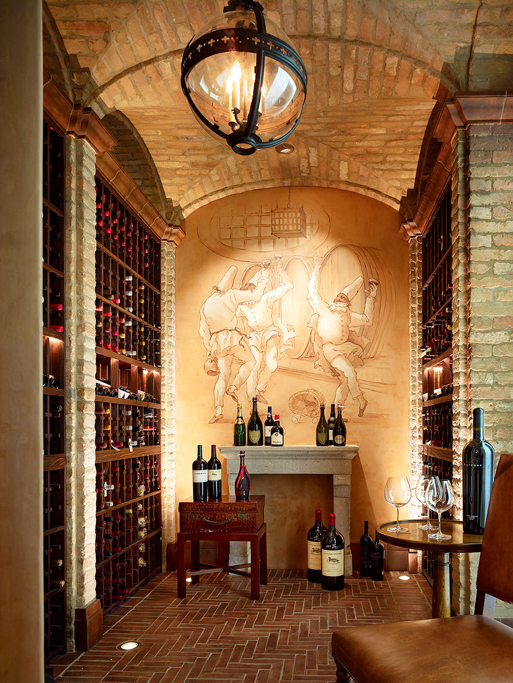 This is an example of a large mediterranean wine cellar in San Francisco with brick floors and storage racks.