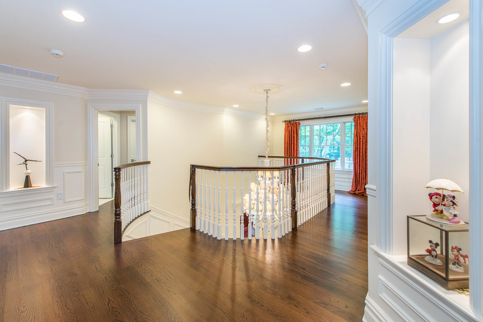 Large traditional hallway in New York with white walls and medium hardwood floors.