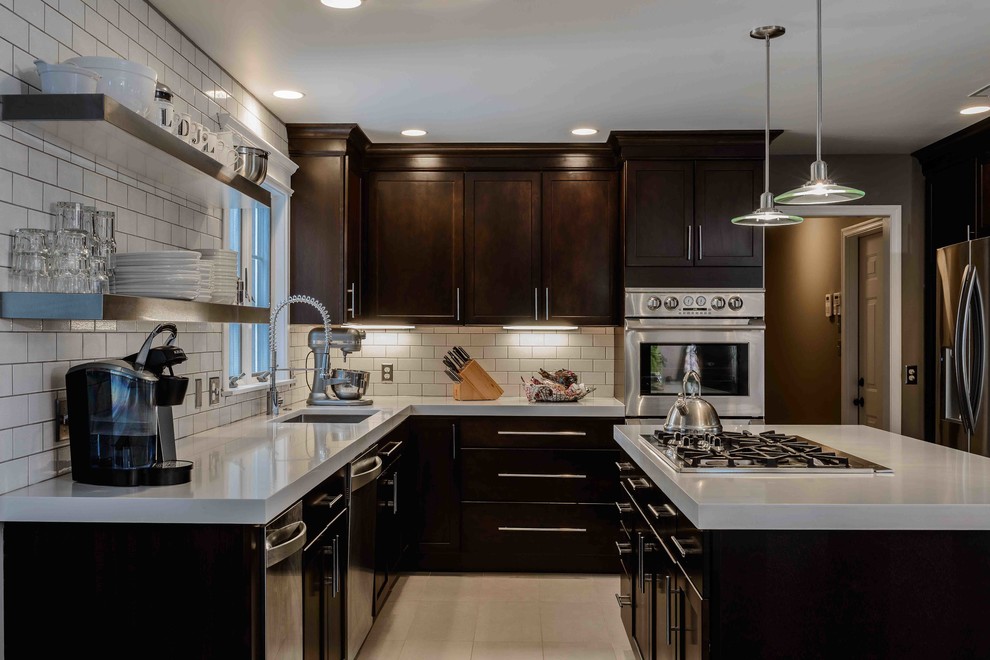This is an example of a contemporary kitchen in Philadelphia with stainless steel appliances and beige floor.