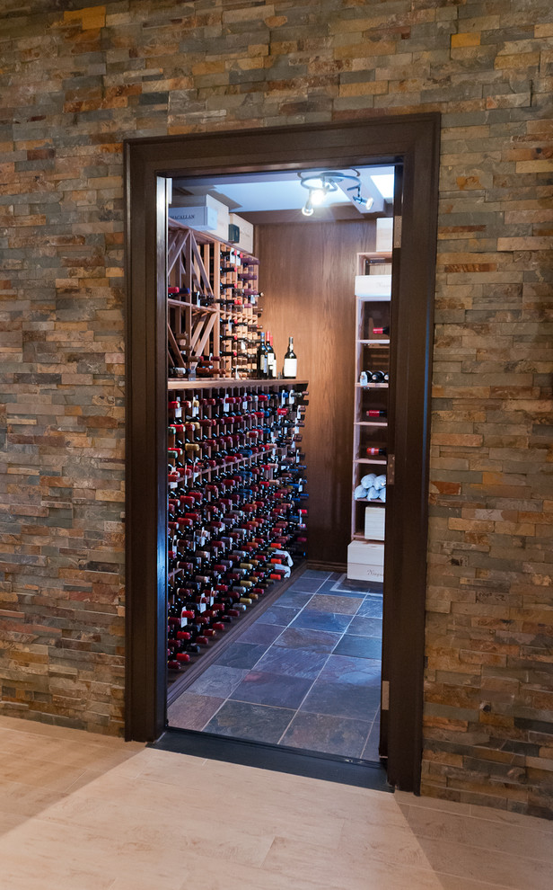 Design ideas for a mid-sized transitional wine cellar in Toronto with slate floors, storage racks and multi-coloured floor.