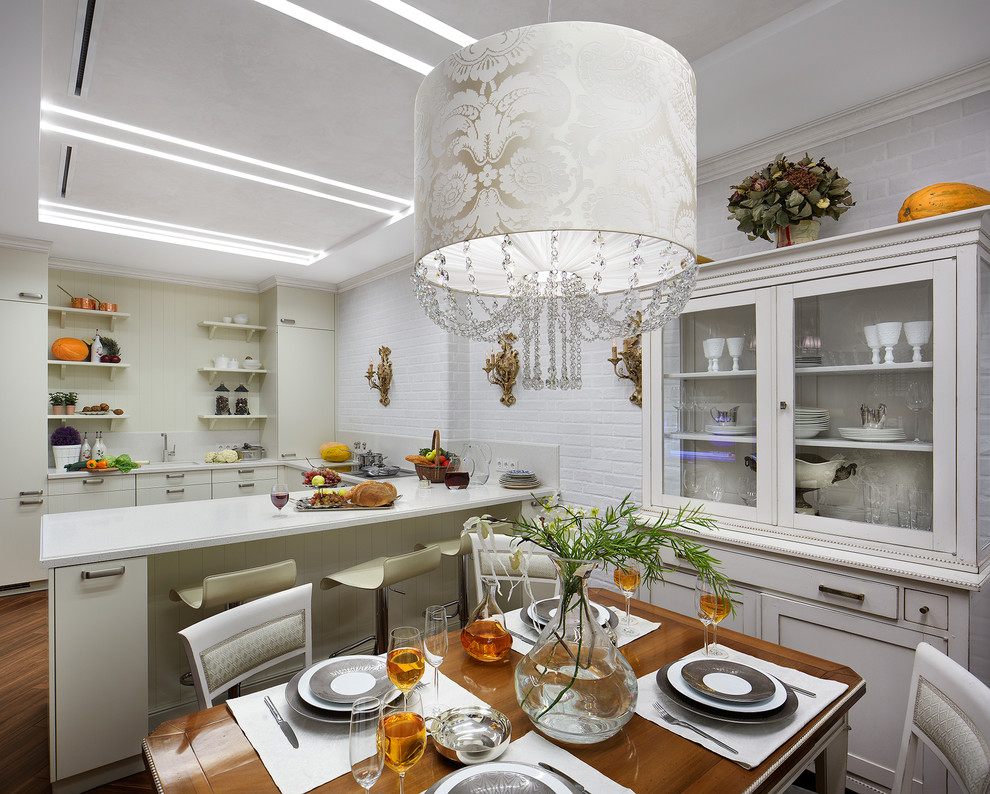Photo of a mid-sized traditional u-shaped eat-in kitchen in Yekaterinburg with ceramic floors, flat-panel cabinets, white cabinets, white splashback and a peninsula.