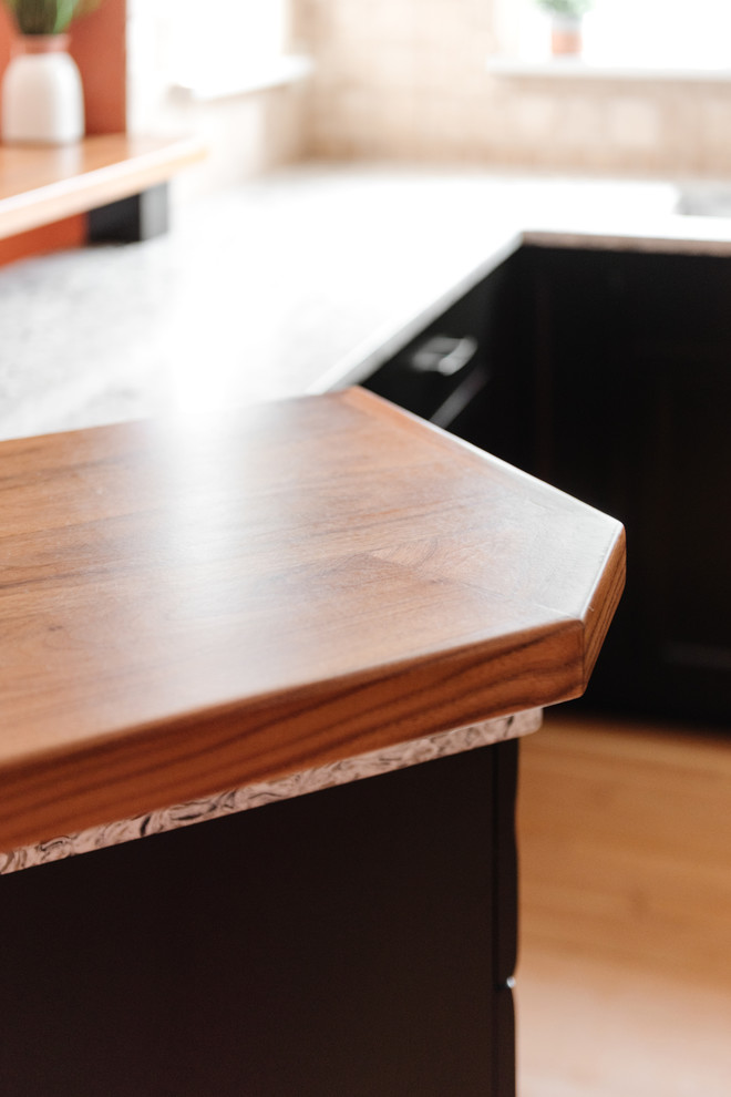 Inspiration for a mid-sized transitional u-shaped medium tone wood floor and brown floor eat-in kitchen remodel with an undermount sink, shaker cabinets, distressed cabinets, quartz countertops, white backsplash, travertine backsplash, stainless steel appliances, a peninsula and multicolored countertops