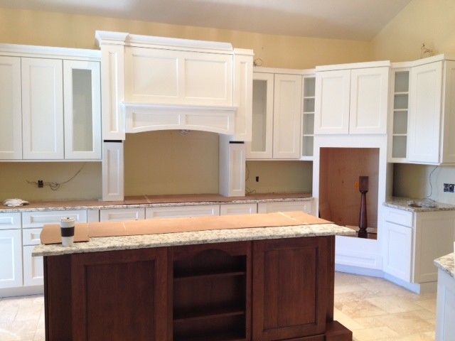Example of a large transitional travertine floor open concept kitchen design with an undermount sink, shaker cabinets, white cabinets, quartz countertops, beige backsplash, subway tile backsplash, stainless steel appliances and an island
