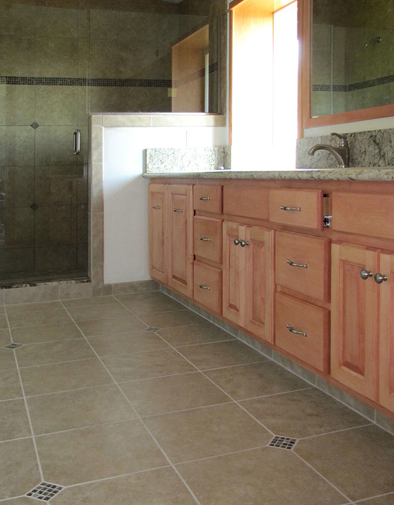 Bathroom - bathroom idea with raised-panel cabinets, white walls and an integrated sink