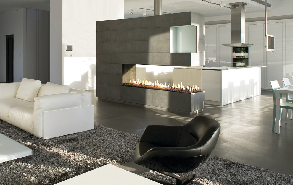 Photo of a contemporary living room in Denver with white walls, concrete floors, a ribbon fireplace, a metal fireplace surround and a wall-mounted tv.