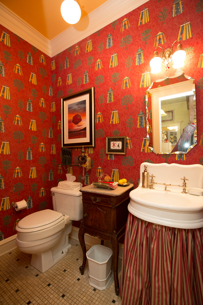 Inspiration for a small eclectic powder room in Other with brown cabinets, a two-piece toilet, red walls, marble floors, a wall-mount sink, marble benchtops and white floor.