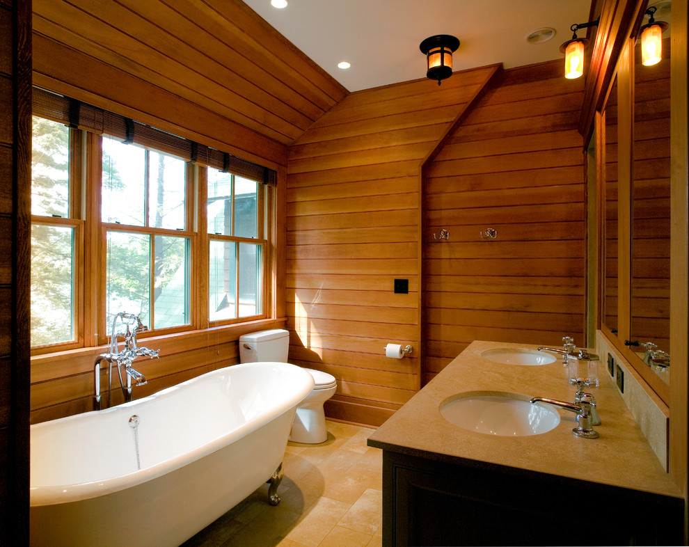 Mid-sized country master bathroom in New York with a claw-foot tub, a one-piece toilet, beige tile, brown walls, an undermount sink, ceramic tile and ceramic floors.