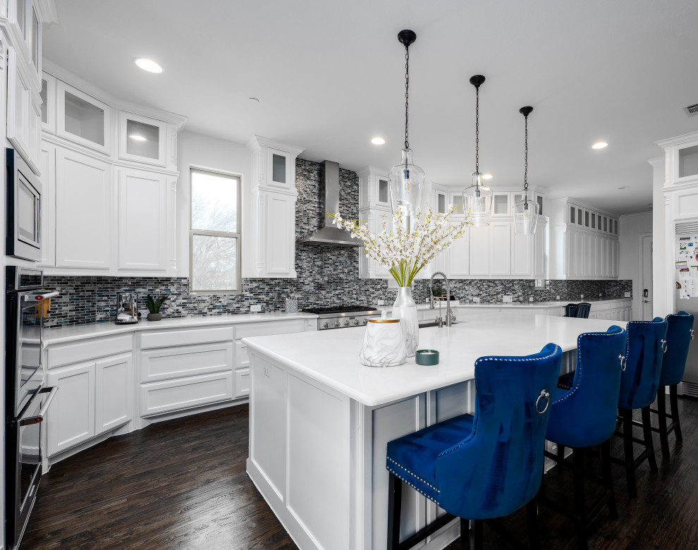 Large transitional eat-in kitchen in Dallas with a single-bowl sink, louvered cabinets, white cabinets, quartzite benchtops, blue splashback, glass tile splashback, stainless steel appliances, dark hardwood floors, with island, brown floor and white benchtop.