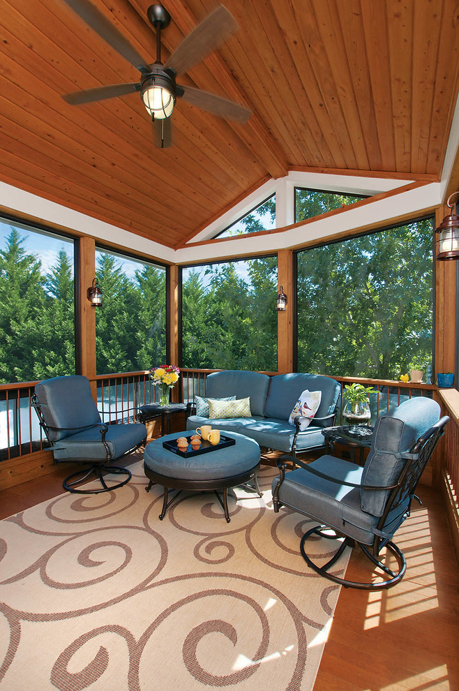 This is an example of a mid-sized traditional backyard screened-in verandah in Atlanta with a roof extension.