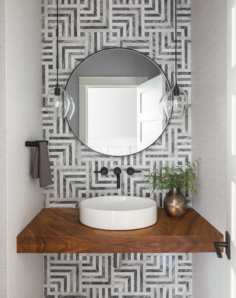Design ideas for a transitional powder room in Seattle with gray tile, grey walls, a vessel sink and brown benchtops.