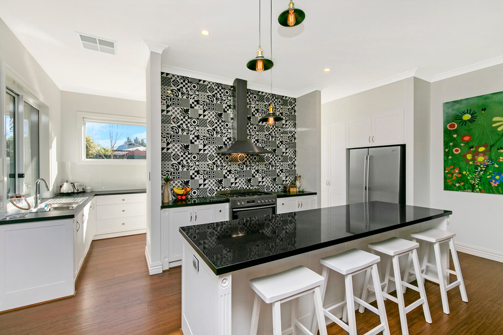 This is an example of a contemporary galley kitchen in Adelaide with a drop-in sink, shaker cabinets, stainless steel appliances, medium hardwood floors and with island.
