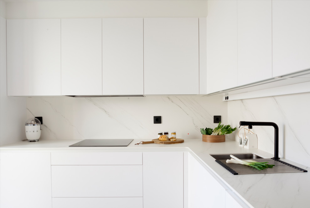 Small modern l-shaped enclosed kitchen in Other with a submerged sink, flat-panel cabinets, white cabinets, engineered stone countertops, beige splashback, engineered quartz splashback, stainless steel appliances, medium hardwood flooring, no island and beige worktops.