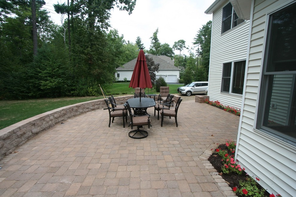 Mid-sized contemporary backyard patio in Boston with concrete pavers.