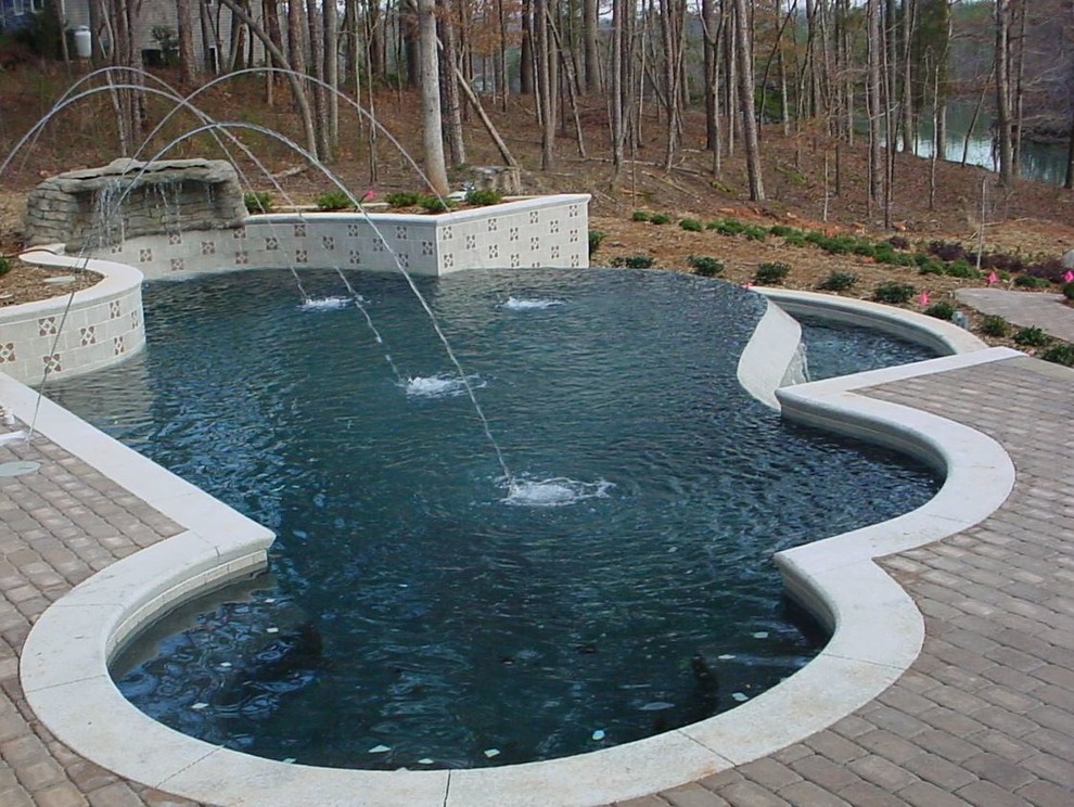 Example of a side yard brick and custom-shaped pool fountain design