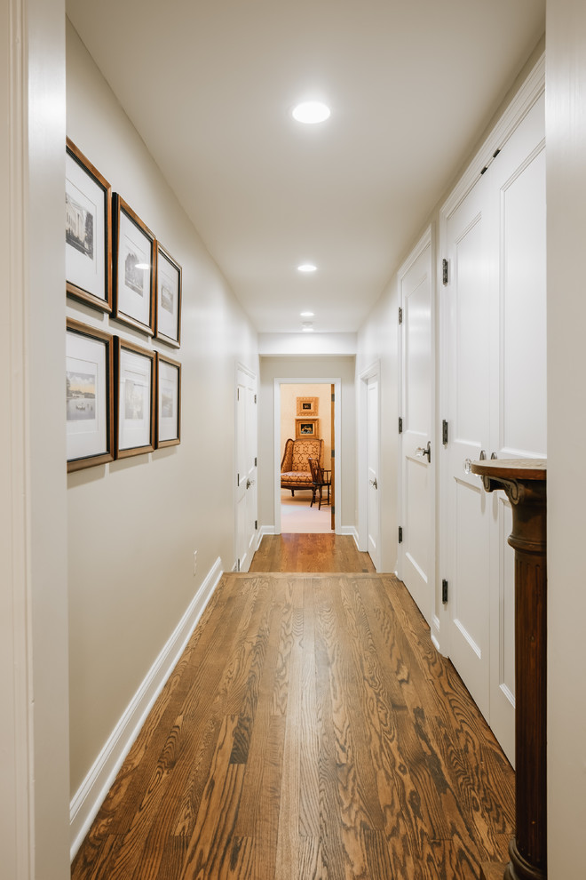 Inspiration for a large traditional hallway in Minneapolis with white walls and light hardwood floors.
