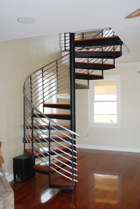 This is an example of a mid-sized contemporary wood spiral staircase in San Diego with wood risers.