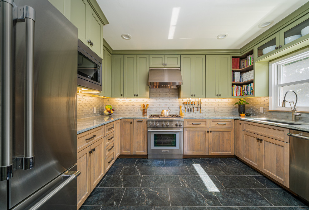 This is an example of a small transitional u-shaped separate kitchen in Other with a single-bowl sink, shaker cabinets, green cabinets, quartzite benchtops, grey splashback, glass tile splashback, stainless steel appliances, porcelain floors, no island, black floor and grey benchtop.