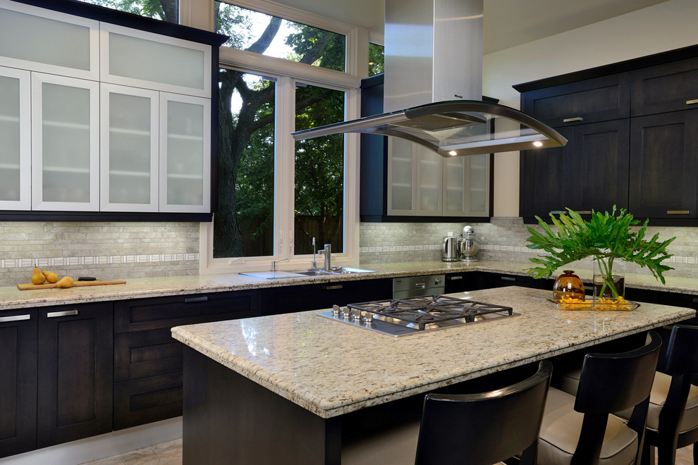 Eat-in kitchen - mid-sized transitional l-shaped travertine floor and beige floor eat-in kitchen idea with an undermount sink, shaker cabinets, dark wood cabinets, granite countertops, gray backsplash, stone tile backsplash, stainless steel appliances and an island