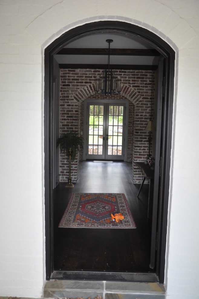Inspiration for a mid-sized transitional dark wood floor and brown floor front door remodel with multicolored walls
