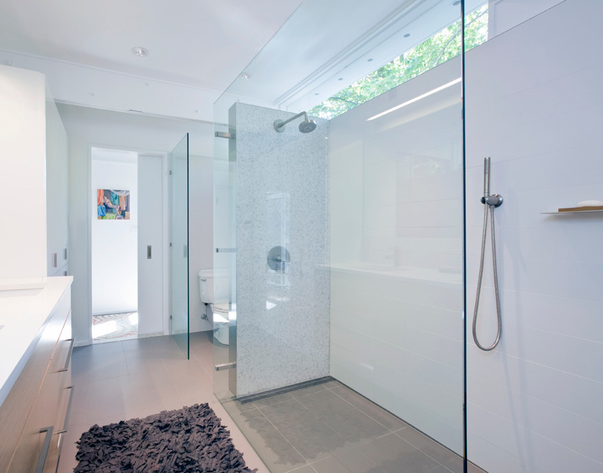 Alcove shower - mid-sized 1960s master white tile and porcelain tile ceramic tile alcove shower idea in Baltimore with furniture-like cabinets, light wood cabinets, quartz countertops, a two-piece toilet, white walls and an undermount sink