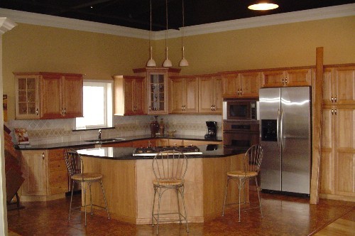 Example of a large light wood floor kitchen design in Minneapolis with an undermount sink, medium tone wood cabinets, multicolored backsplash, stainless steel appliances and an island