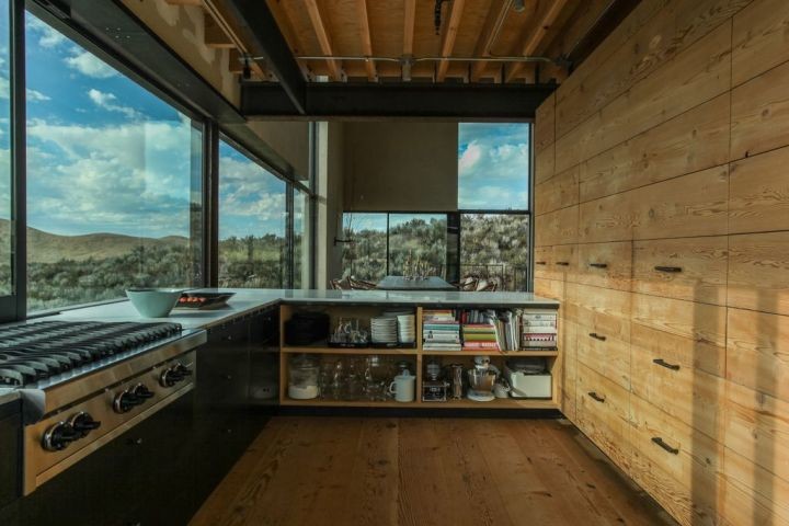 Example of a mountain style l-shaped enclosed kitchen design in Boise with light wood cabinets and flat-panel cabinets