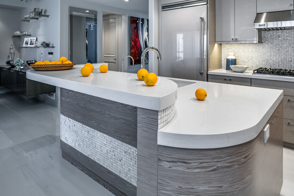 This is an example of a mid-sized modern l-shaped open plan kitchen in Phoenix with an undermount sink, flat-panel cabinets, beige cabinets, quartz benchtops, multi-coloured splashback, mosaic tile splashback, panelled appliances, porcelain floors, with island, white floor and white benchtop.