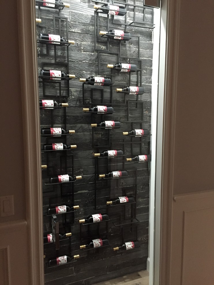 Wine cellar - mid-sized contemporary light wood floor wine cellar idea in Los Angeles with display racks