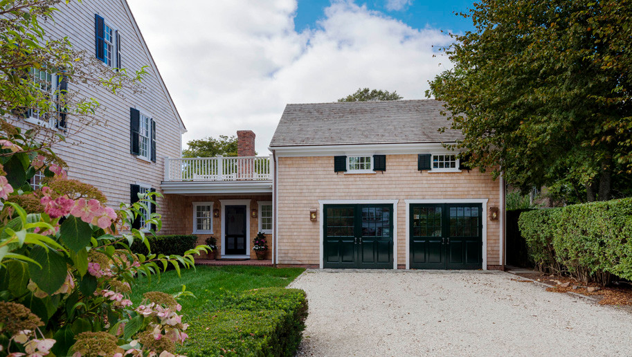This is an example of a mid-sized beach style attached two-car garage in Boston.