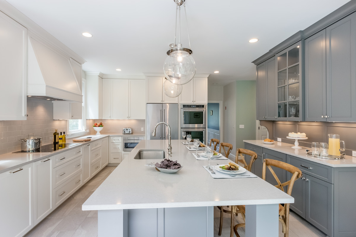 Inspiration for a transitional kitchen remodel in Boston with an undermount sink, gray cabinets, quartzite countertops, subway tile backsplash, stainless steel appliances and an island