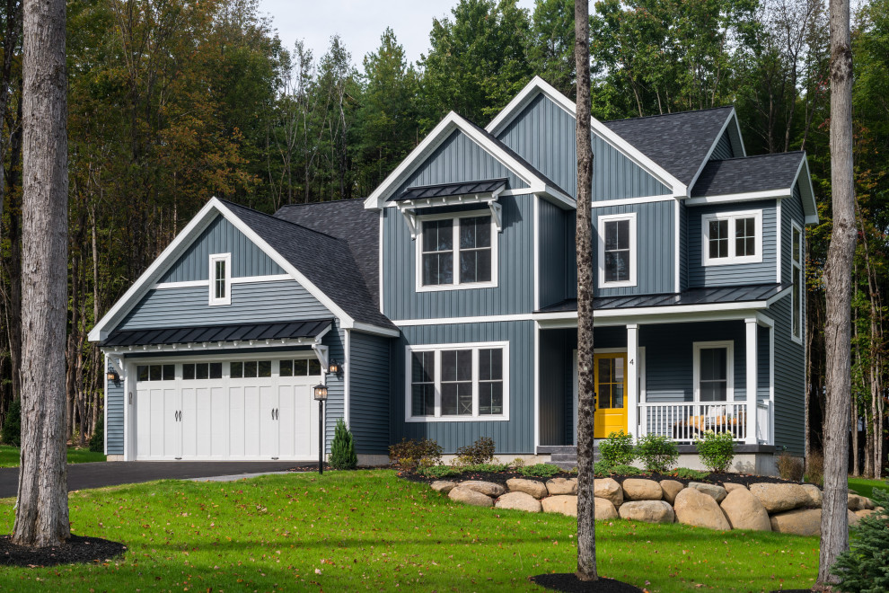 This is an example of a country two-storey blue house exterior in Other with vinyl siding, a shingle roof and a black roof.