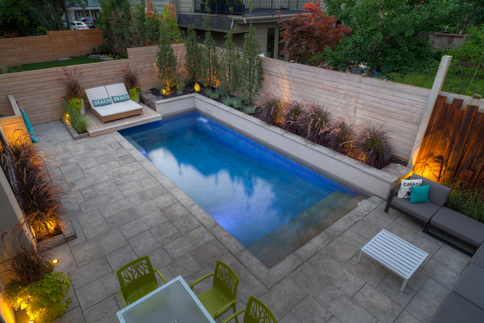 Design ideas for a small traditional backyard rectangular pool in Other with a water feature and natural stone pavers.
