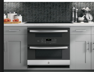 induction cooktop, wall oven underneath and downdraft hood in island