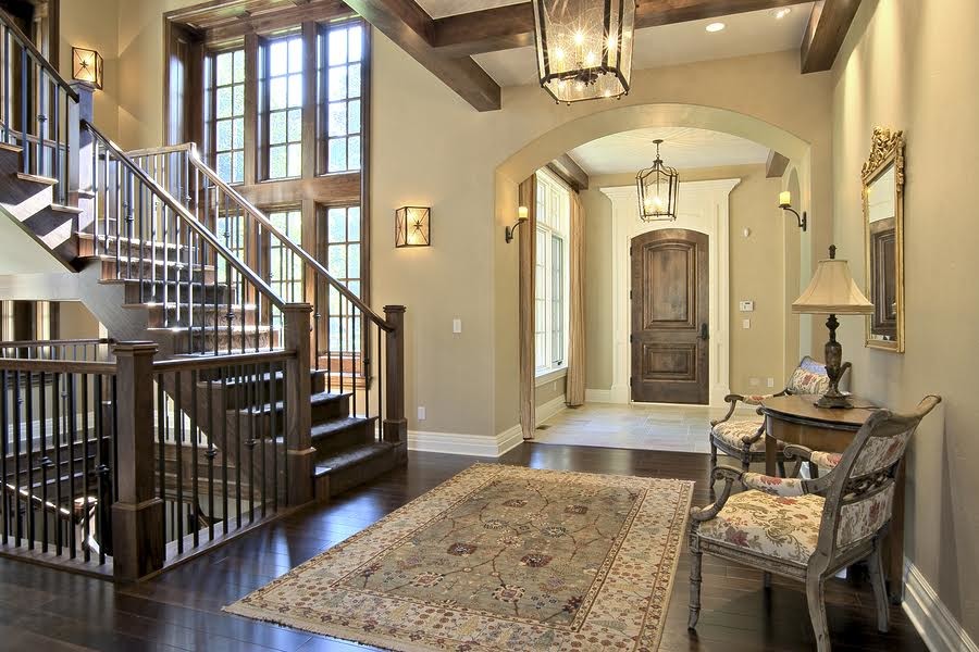 This is an example of a mid-sized country hallway in Other with beige walls and dark hardwood floors.