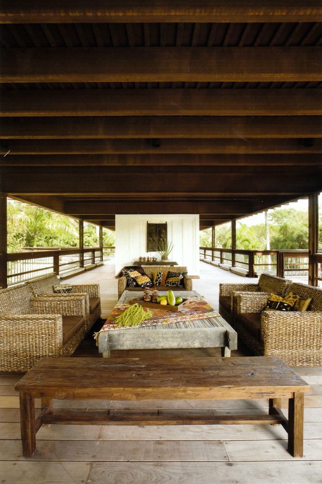 This is an example of an expansive country deck in Miami with a roof extension.
