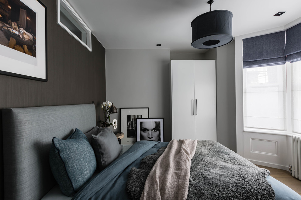 Inspiration for a mid-sized scandinavian master bedroom in London with grey walls, light hardwood floors and beige floor.