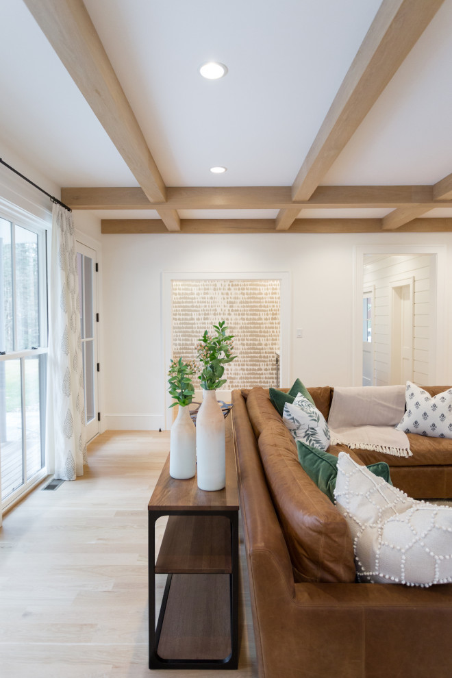 Inspiration for a country enclosed medium tone wood floor family room remodel in Boston