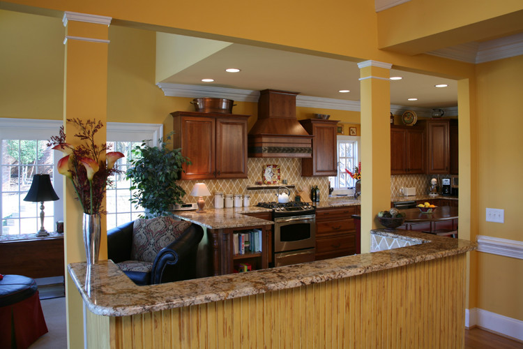 Example of a large transitional u-shaped medium tone wood floor open concept kitchen design in Charlotte with an undermount sink, raised-panel cabinets, dark wood cabinets, granite countertops, ceramic backsplash, stainless steel appliances and an island