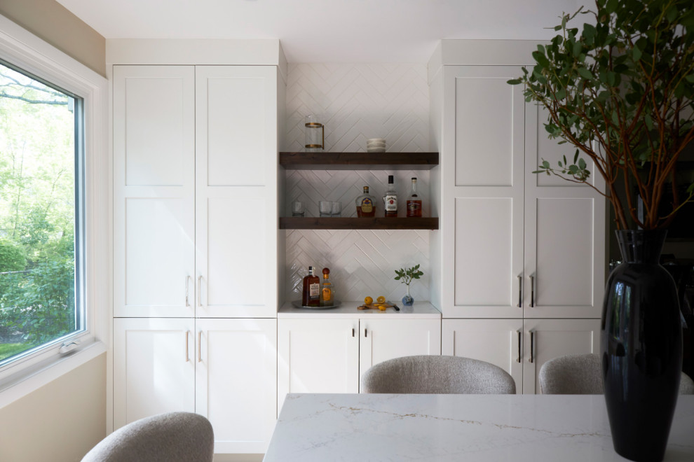 Inspiration for a large transitional u-shaped light wood floor, brown floor and coffered ceiling eat-in kitchen remodel in Chicago with a farmhouse sink, shaker cabinets, white cabinets, quartz countertops, white backsplash, subway tile backsplash, stainless steel appliances, an island and multicolored countertops
