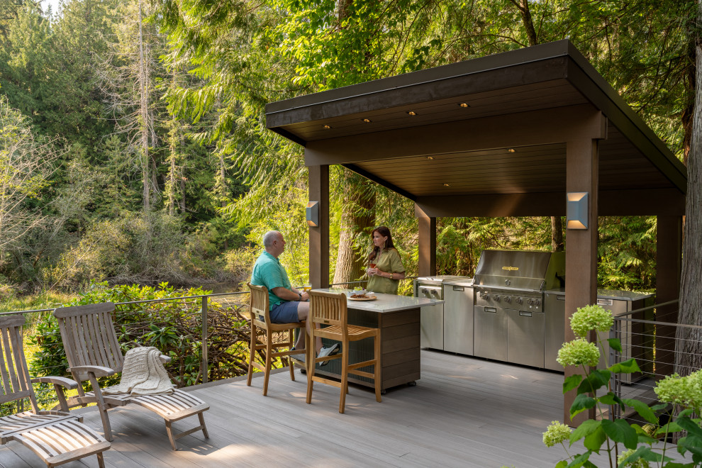 Example of a large trendy backyard ground level metal railing outdoor kitchen deck design in Seattle with a pergola