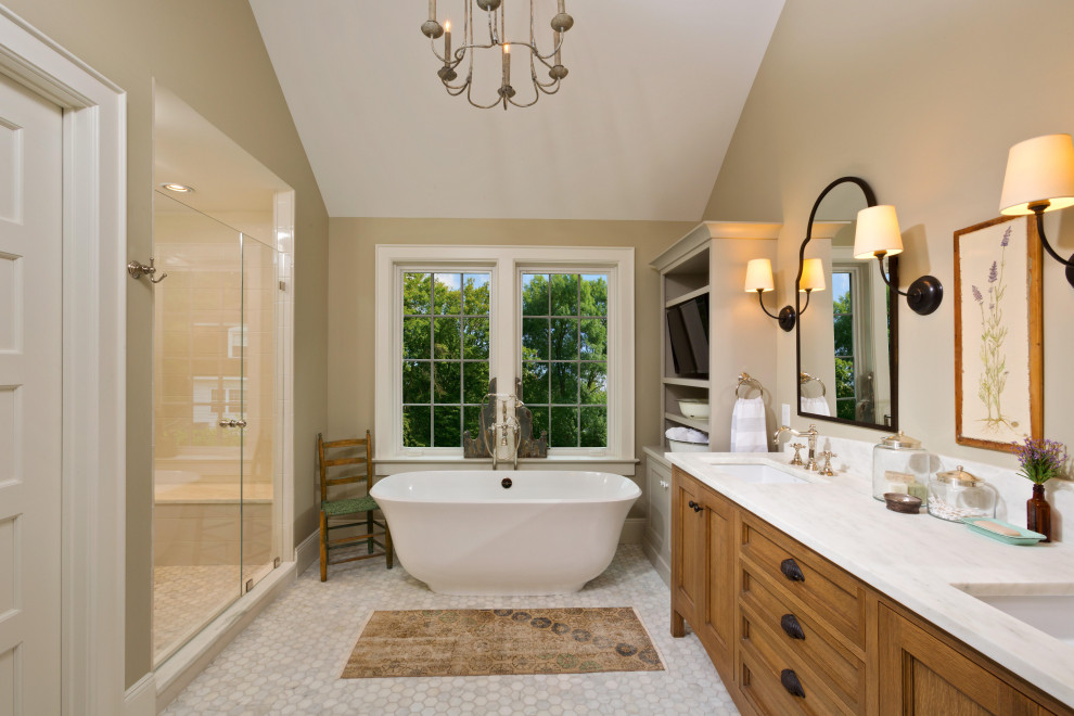 Inspiration for a large traditional master bathroom in New York with furniture-like cabinets, brown cabinets, a freestanding tub, white tile, ceramic tile, beige walls, porcelain floors, an undermount sink, white floor, a hinged shower door, white benchtops, a shower seat, a double vanity, a floating vanity and vaulted.