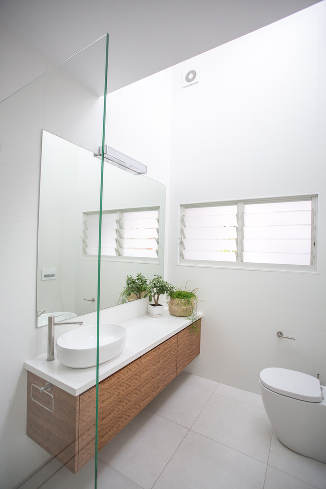 This is an example of a mid-sized contemporary master bathroom in Sydney with white tile, porcelain tile, white walls, a vessel sink, engineered quartz benchtops, white floor, an open shower and white benchtops.