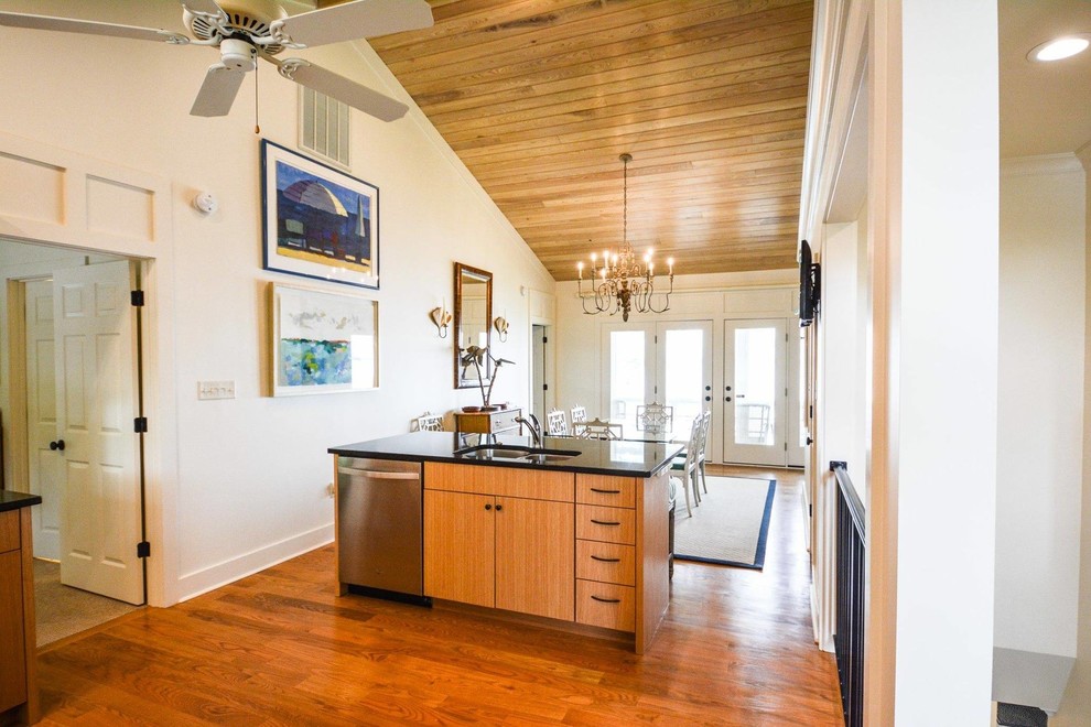 Inspiration for a mid-sized transitional l-shaped medium tone wood floor and brown floor open concept kitchen remodel with flat-panel cabinets, medium tone wood cabinets, quartz countertops, stainless steel appliances and no island