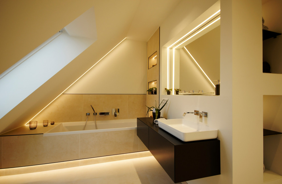Mid-sized scandinavian bathroom in Munich with flat-panel cabinets, a drop-in tub, wood benchtops and black benchtops.