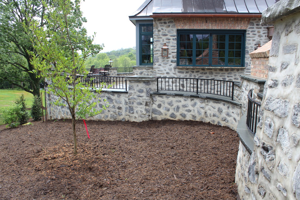 Example of a mid-sized mountain style backyard patio design