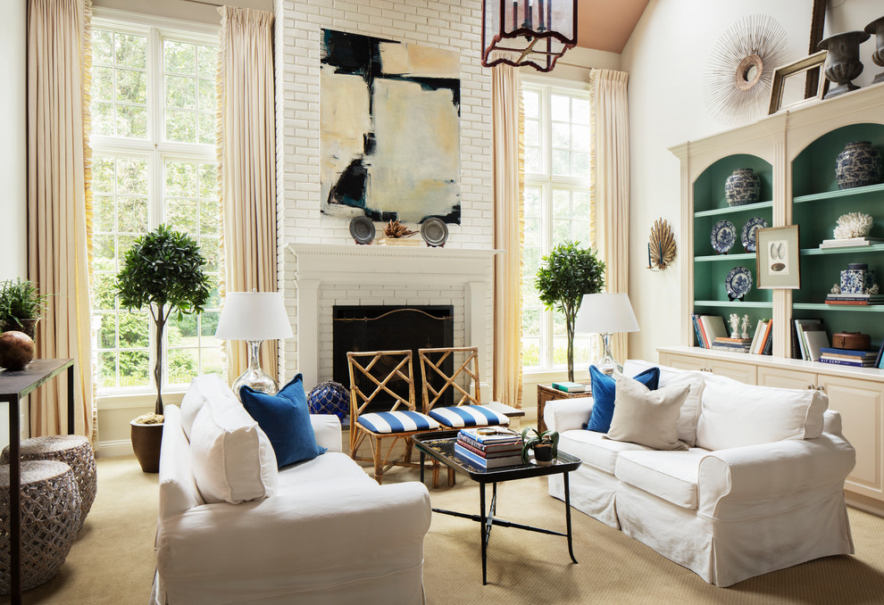 Design ideas for an eclectic formal enclosed living room in New York with white walls, carpet, a standard fireplace, a brick fireplace surround, no tv and beige floor.