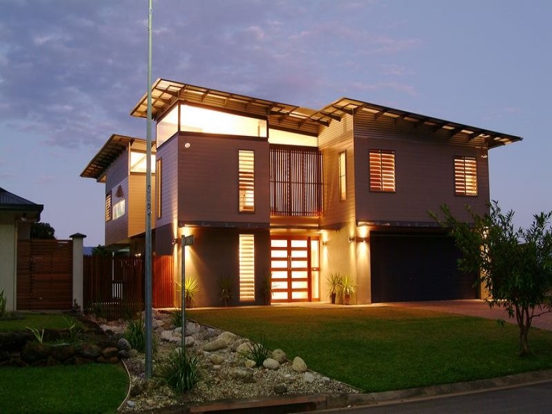 Mid-sized contemporary two-storey exterior in Cairns with wood siding and a flat roof.