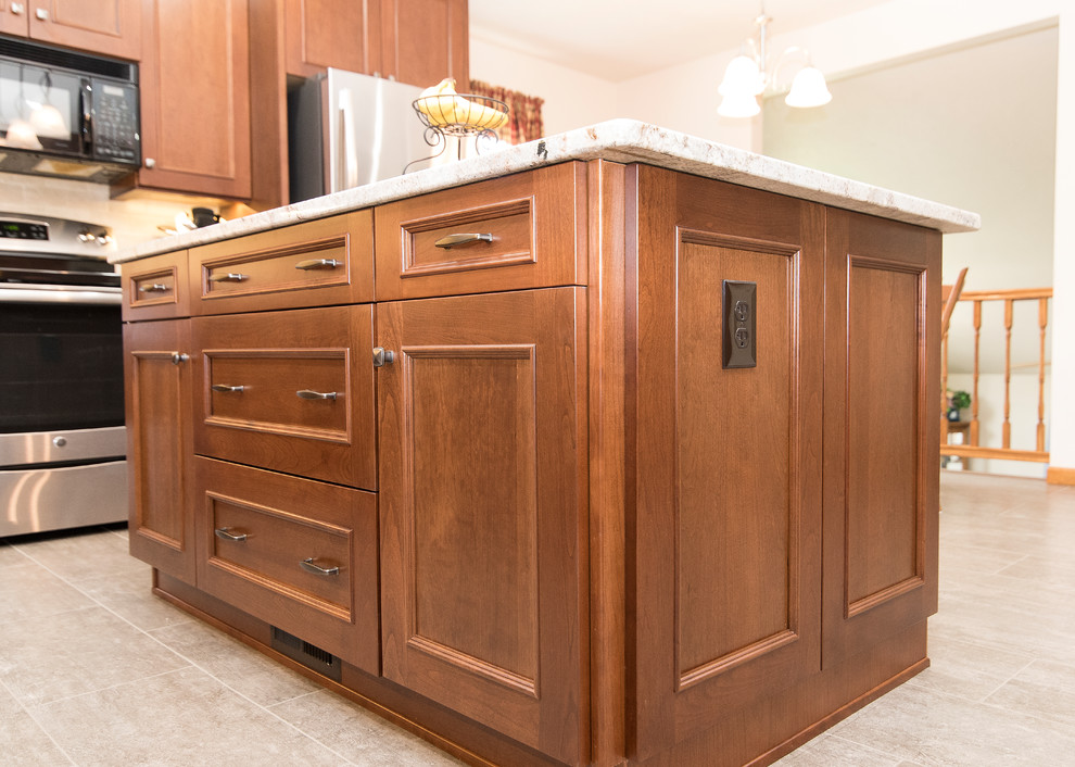 Large elegant l-shaped vinyl floor and beige floor eat-in kitchen photo in Baltimore with an undermount sink, shaker cabinets, medium tone wood cabinets, granite countertops, beige backsplash, ceramic backsplash, stainless steel appliances, an island and white countertops